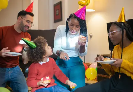 A group of people sitting around a living room.